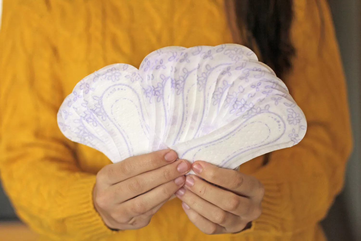 person holding sanitary pads