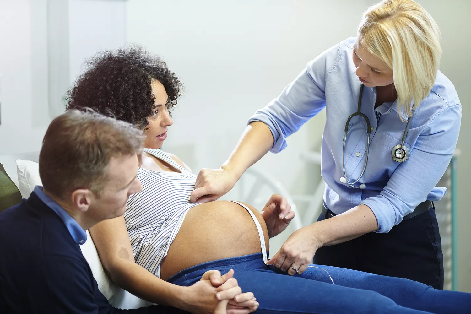 a pregnant lady is examined by midwife at the clinic